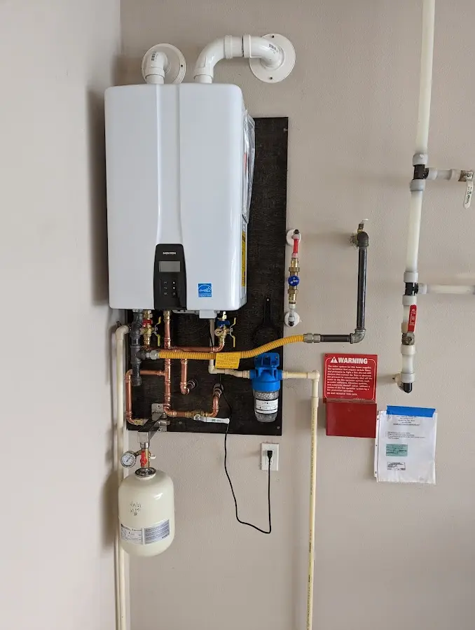 Professional plumber installing copper piping in a Dunlap home